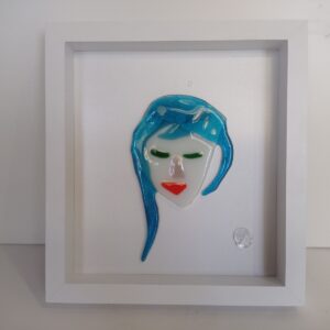 abstract female face with blue hair and red lipstick in glass picture frame